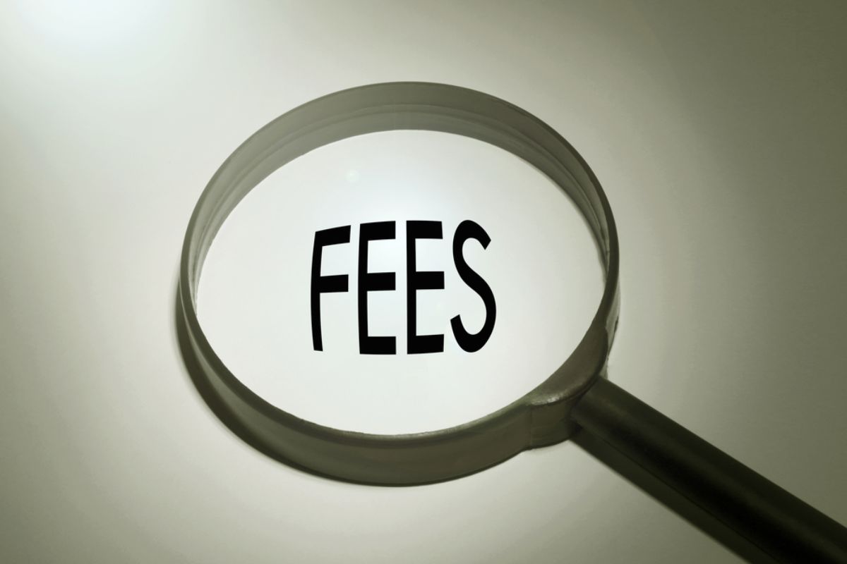 a magnifying glass hovering over the word fees